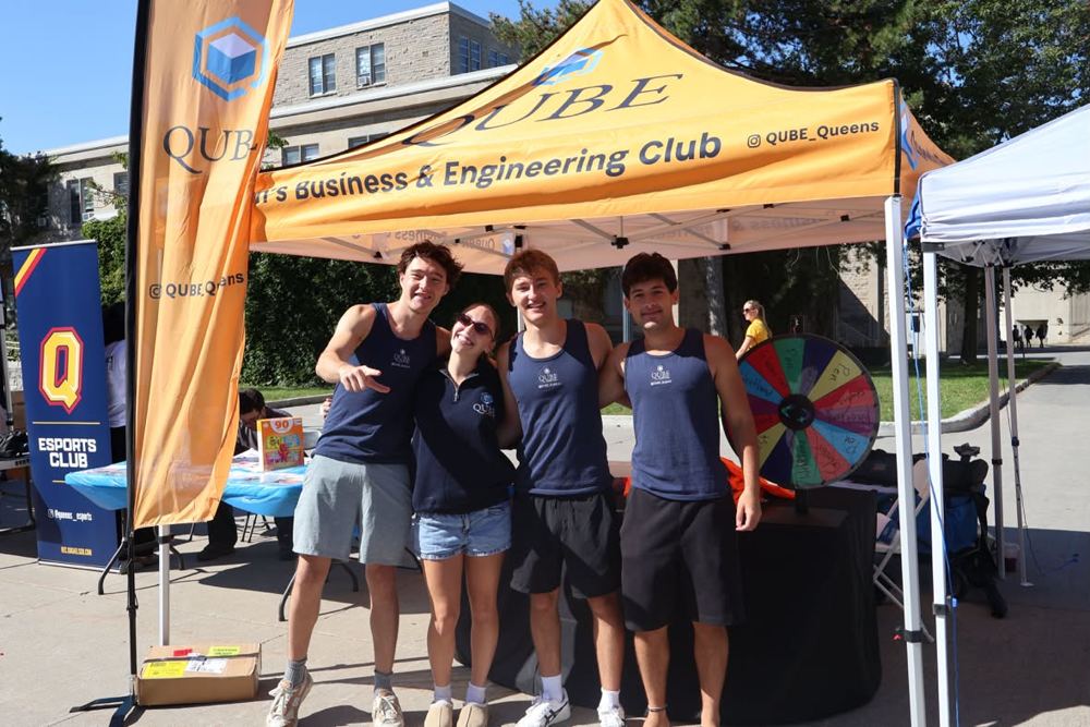 The QUBE team at the club's tent on campus